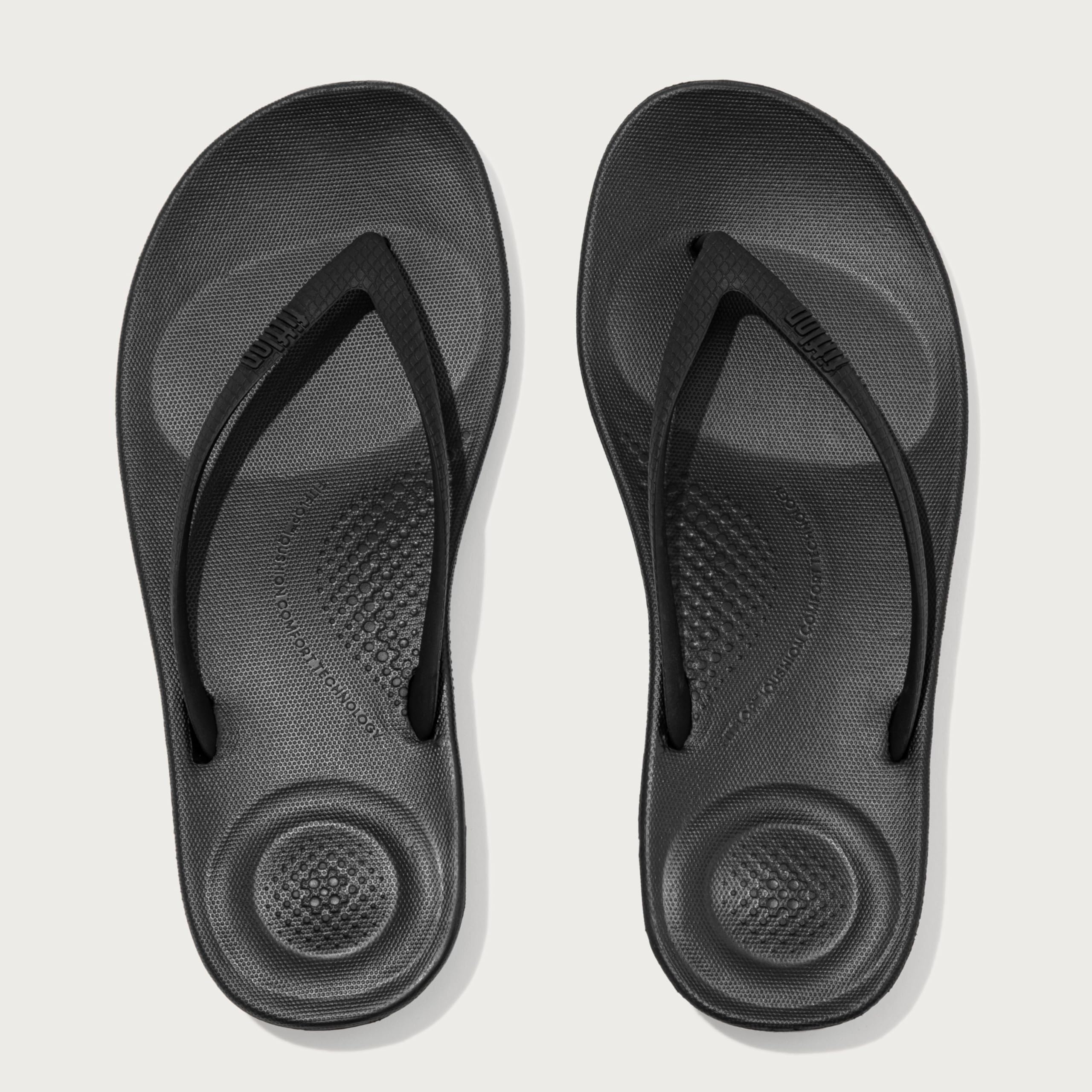 FitFlop Women's iQushion Rubber Flip-Flips with Contoured Footbed for Walking, Lightweight Ergonomic Flip Flop Sandals with Arch Support and Foot Impact Pillows, All Black, 8 US Women